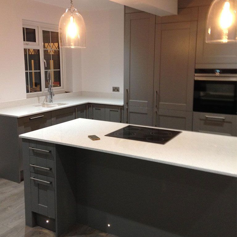 A high-end refurbished kitchen with an island and pendant lights